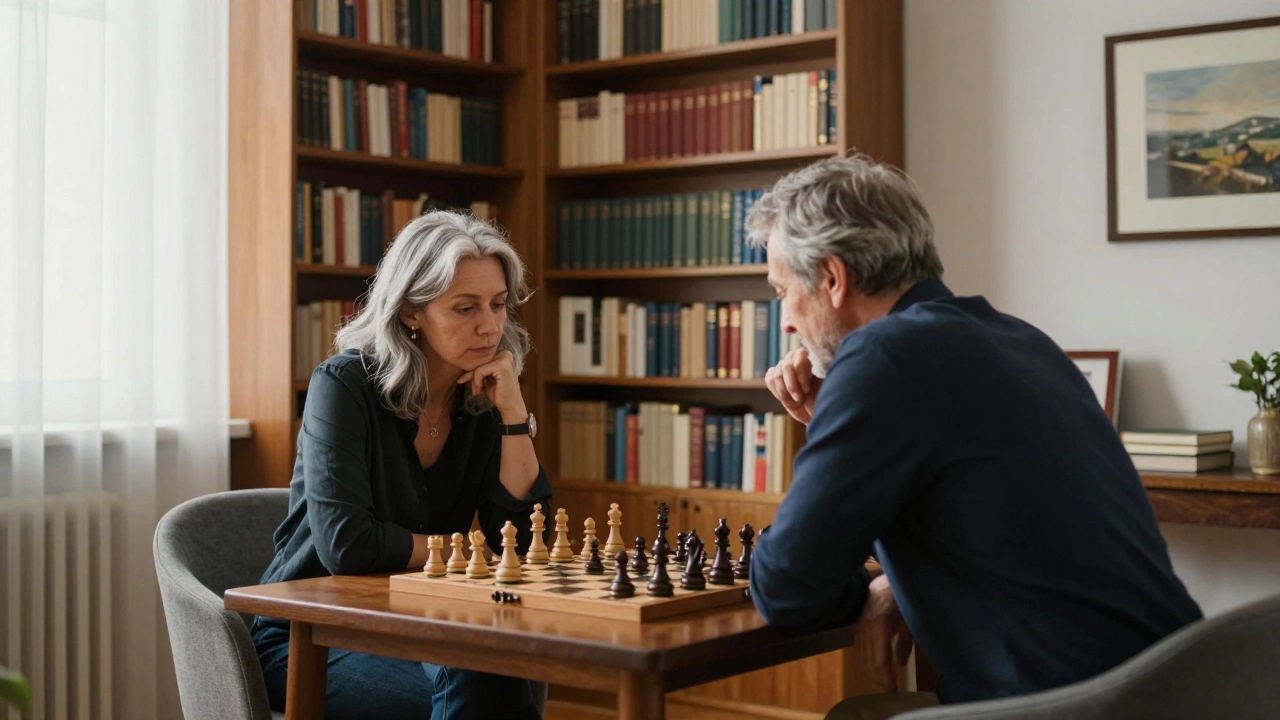 An older woman and man engaged in thoughtful dialogue over a chessboard in a book-lined study.